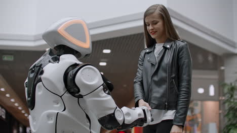 Woman-smiling-shaking-hands-work.-Be-friends-with-cyborg.-Enter-into-an-agreement-with-the-robot